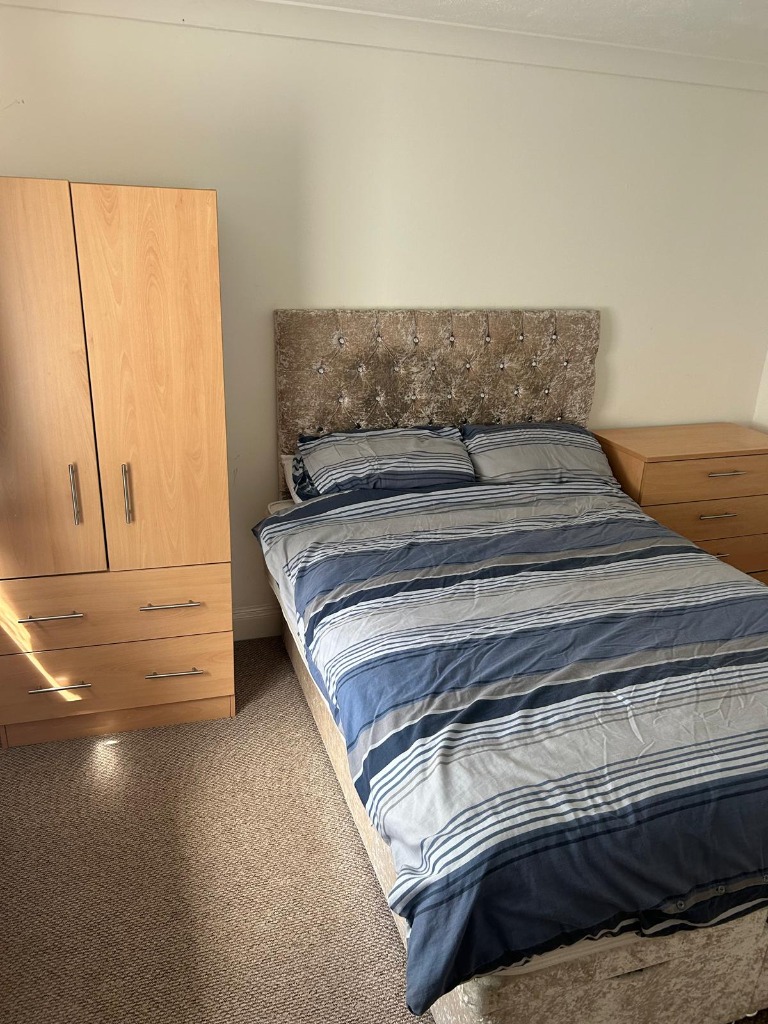 Private bedroom at Bannies Place with wardrobe, bed, and chest of drawers