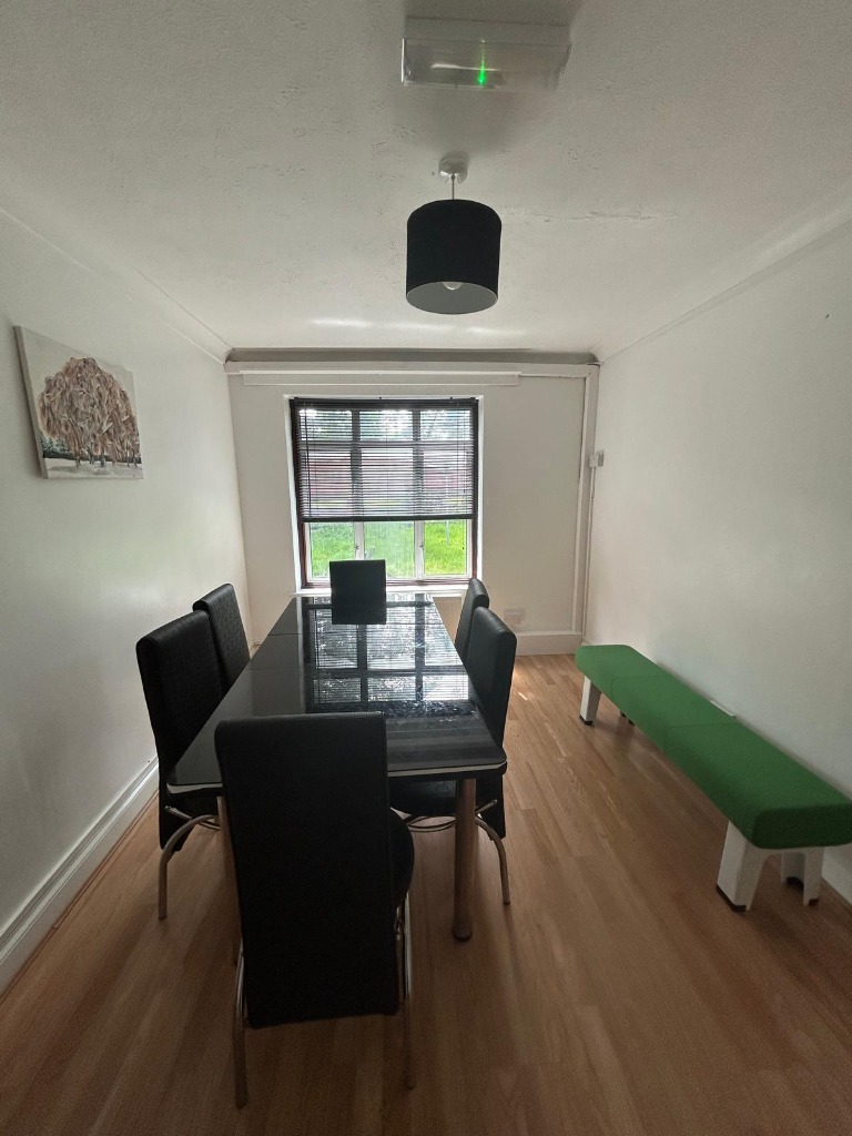 Communal dining room and activity area with dining table and bench seating